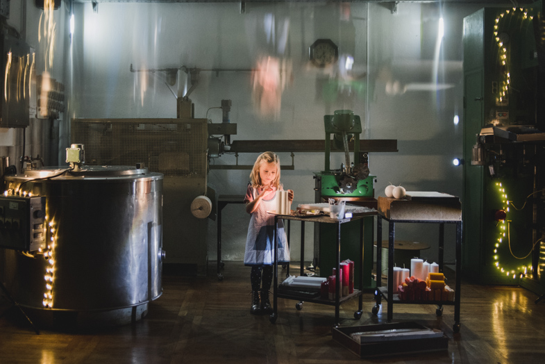 61/5000 A unique photo of a child representing the making of candles.