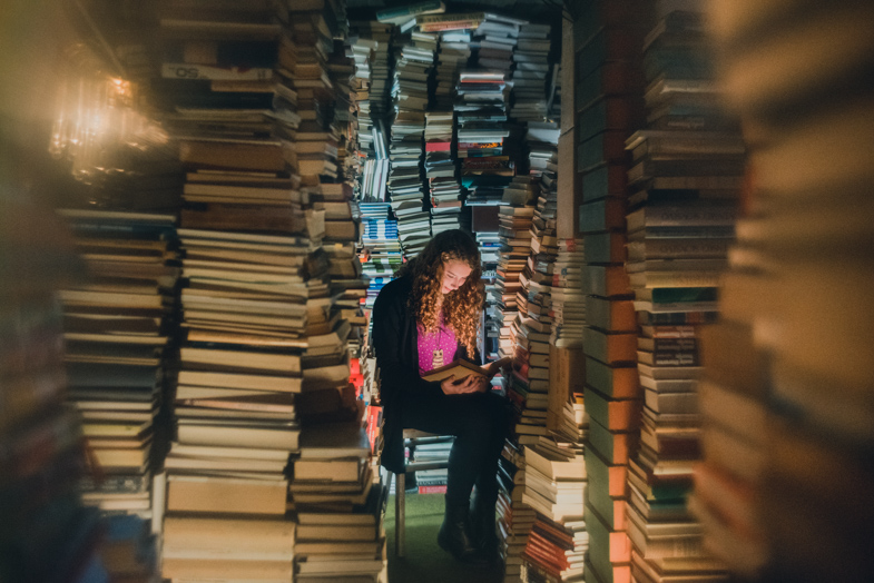 A unique picture of a girl while reading a book.