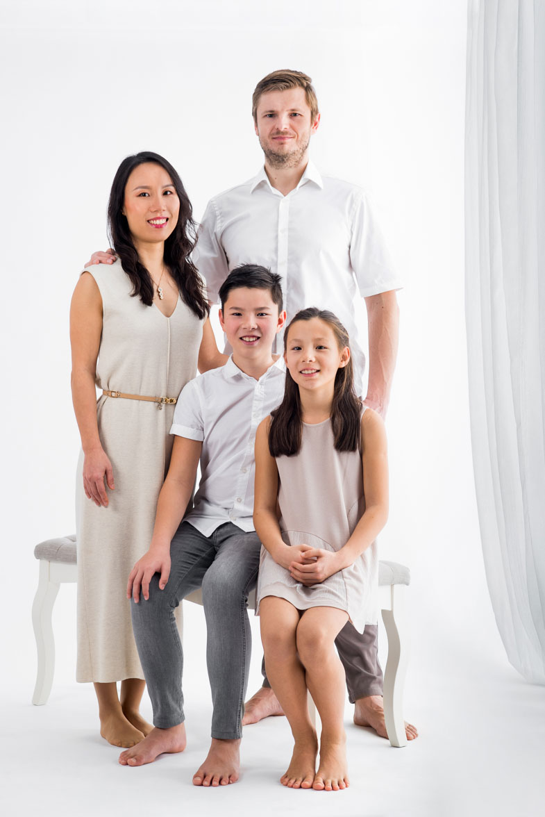A classic portrait of a family in a photographic studio.